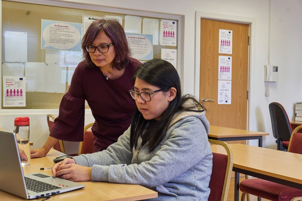 Good Toshiba Laptops for Education - Smart Choices for Smart Minds  - a woman showing a woman something on the laptop